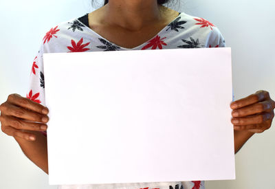 Low section of woman standing on paper