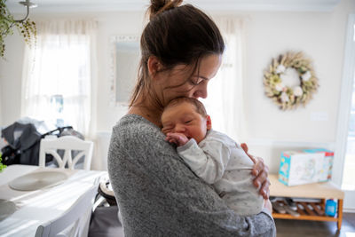 New mother in love holding her precious baby.