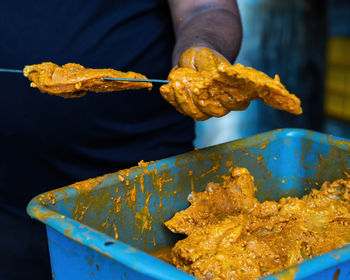 Midsection of man preparing food