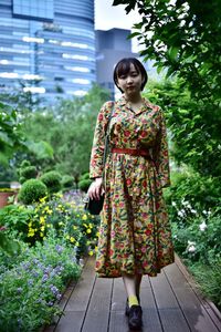 Full length of woman standing against plants