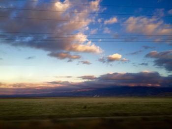 Scenic view of field against sky during sunset