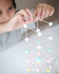 Stem education, child learning making 3d geometric shapes, building structure.