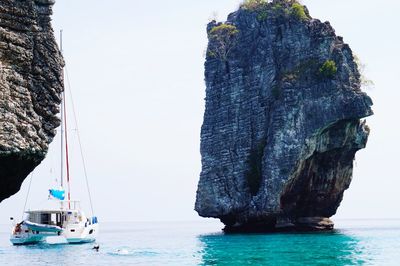 Panoramic view of rock formation in sea against clear sky