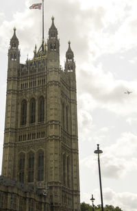 Low angle view of building against cloudy sky