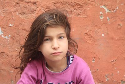 Portrait of teenage girl against wall