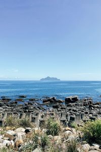 Scenic view of sea against clear blue sky