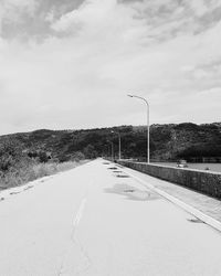 Street by road against sky