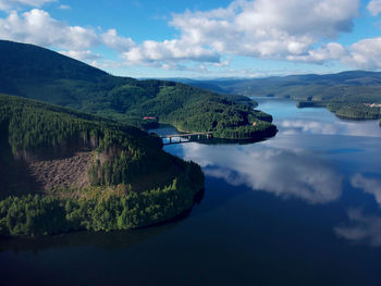 Scenic view of lake and mountains against sky