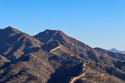 Scenic view of mountains against clear blue sky