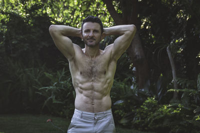 Portrait of young man exercising in park