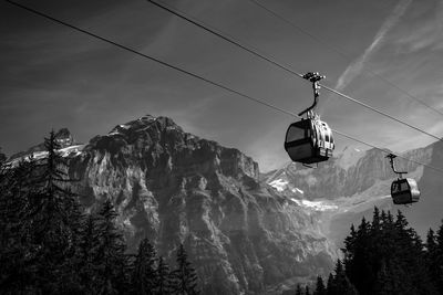 Low angle view of overhead cable car against sky