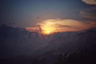 Scenic view of silhouette mountains against sky at sunset