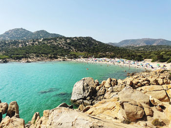 Scenic view of sea and mountains against clear sky