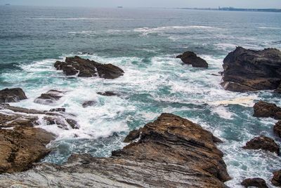 Scenic view of rocks in sea against sky