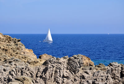 Boat sailing on sea against sky