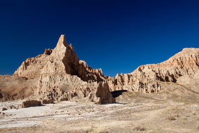 Scenic view of rocky mountains against clear blue sky