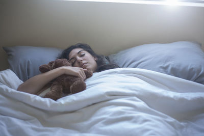 Young woman sleeping on bed