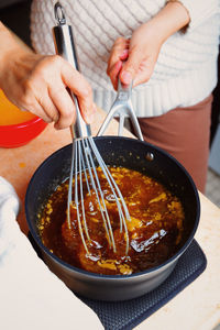 Midsection of woman preparing food in kitchen