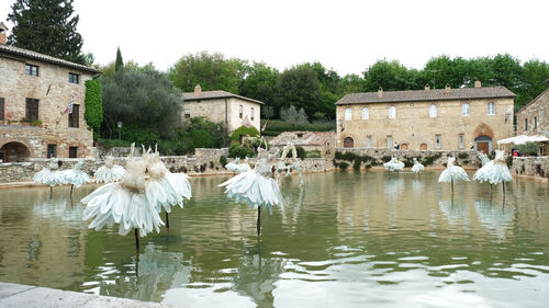 Panoramic view of lake and buildings against sky