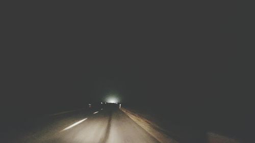 Road in illuminated tunnel