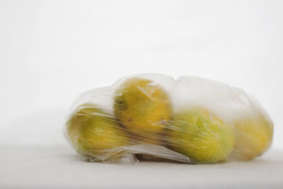 Close-up of lemon slice over white background