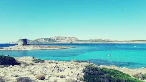 Scenic view of sea against clear blue sky