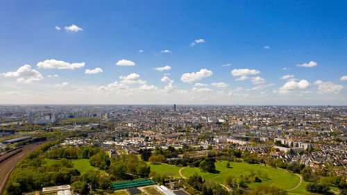 High angle view of townscape by sea against sky