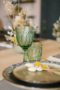 A beautiful festive dining table in the rustic style. green glass tumbler and glass