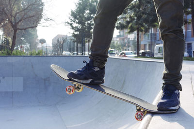 Low section of man skateboarding in park