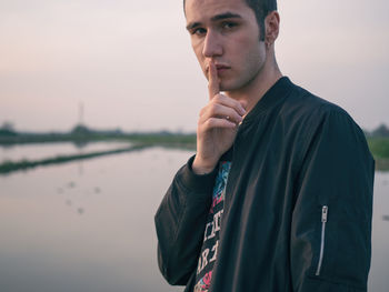 Portrait of man in city against sky