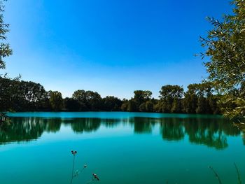 Scenic view of lake against blue sky