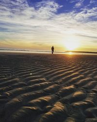 Scenic view of beach against sky during sunset