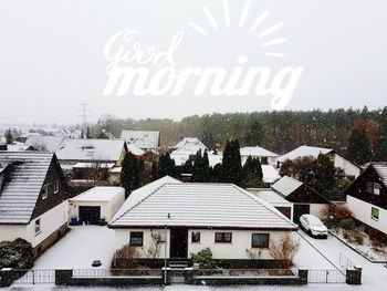 Buildings in city against sky during winter
