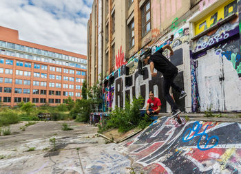 Graffiti on building by street in city