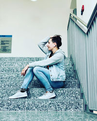 Full length of woman sitting outdoors