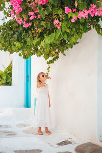 Woman standing by flowering plants