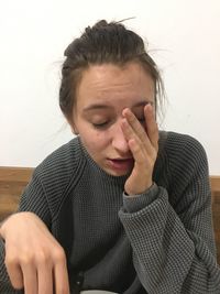 Close-up of tired woman sitting at home