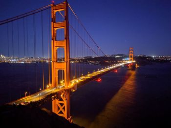 Illuminated suspension bridge at night