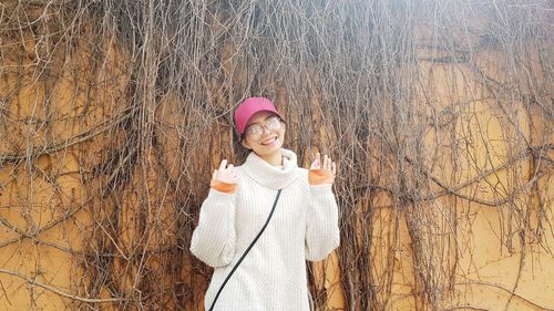 Portrait of smiling woman standing in snow