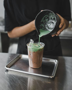 Midsection of woman holding drink