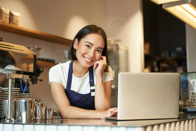 Young woman using laptop at home