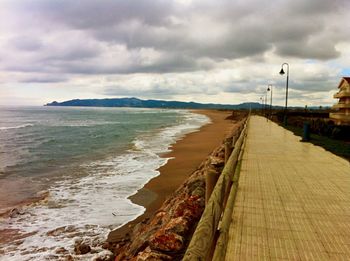 View of seascape against cloudy sky