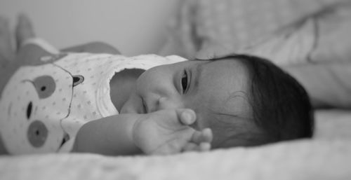 Portrait of cute newborn baby sleeping on bed