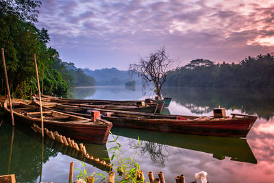 Boats moored in lake against sky