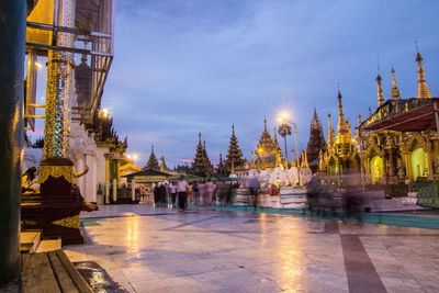 Panoramic view of illuminated temple building against sky at dusk