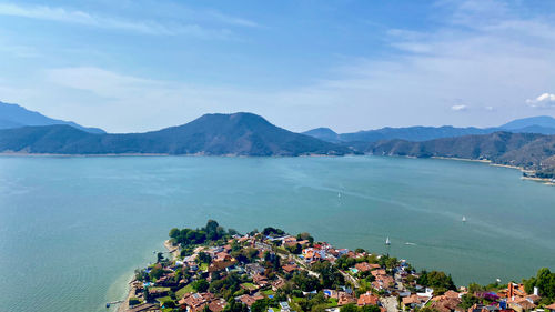Scenic view of sea and mountains against sky
