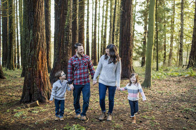 Loving family of four enjoying time together outdoors.