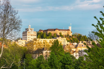 Buildings in town against sky