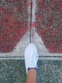 High level view of tennis shoe on asphalt pitch floor