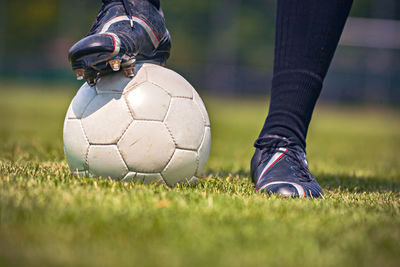 Low section of man relaxing on soccer field